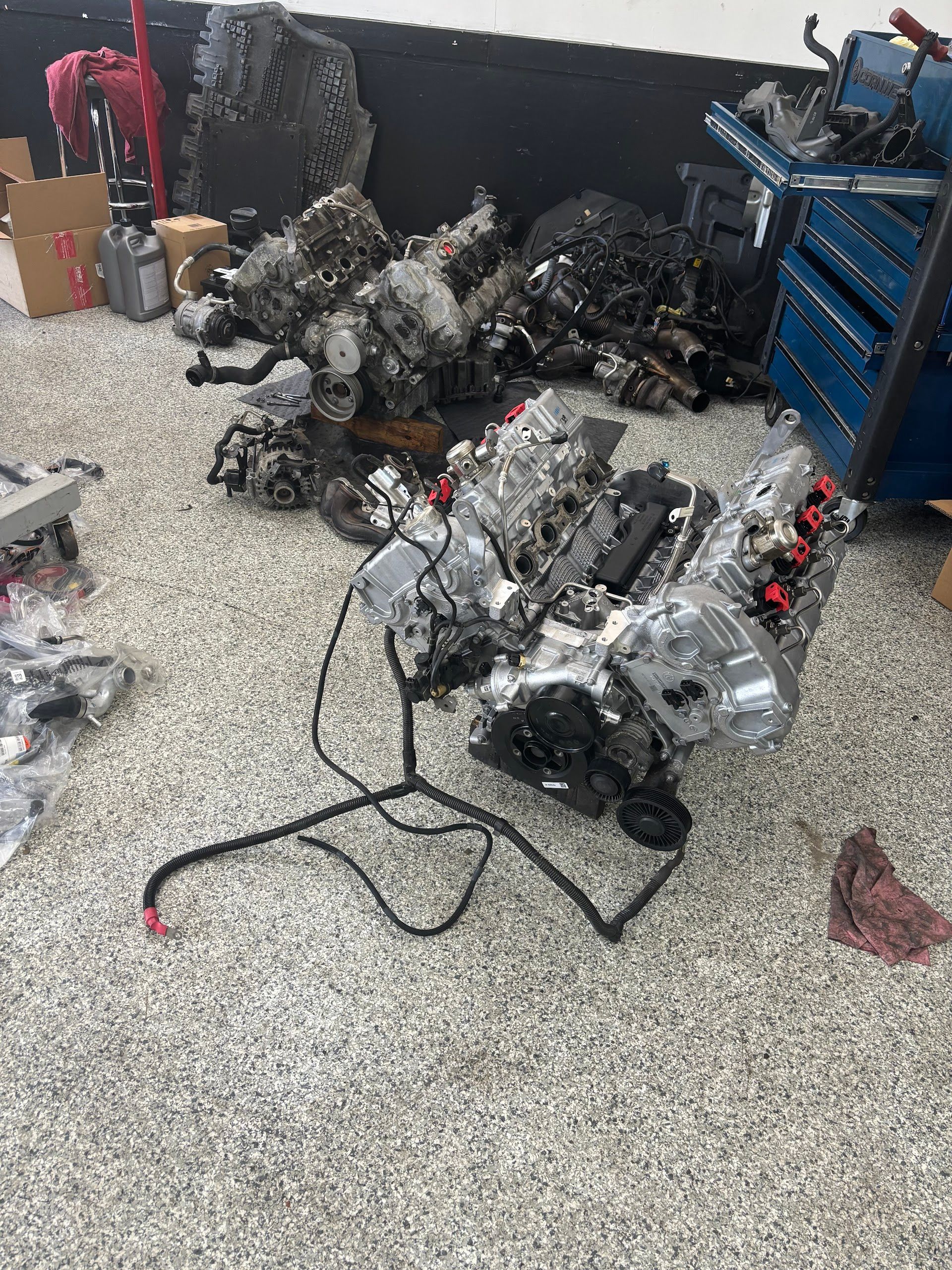 Auto Shop Floor With Engines And Parts For Repair | Extreme Boost Care