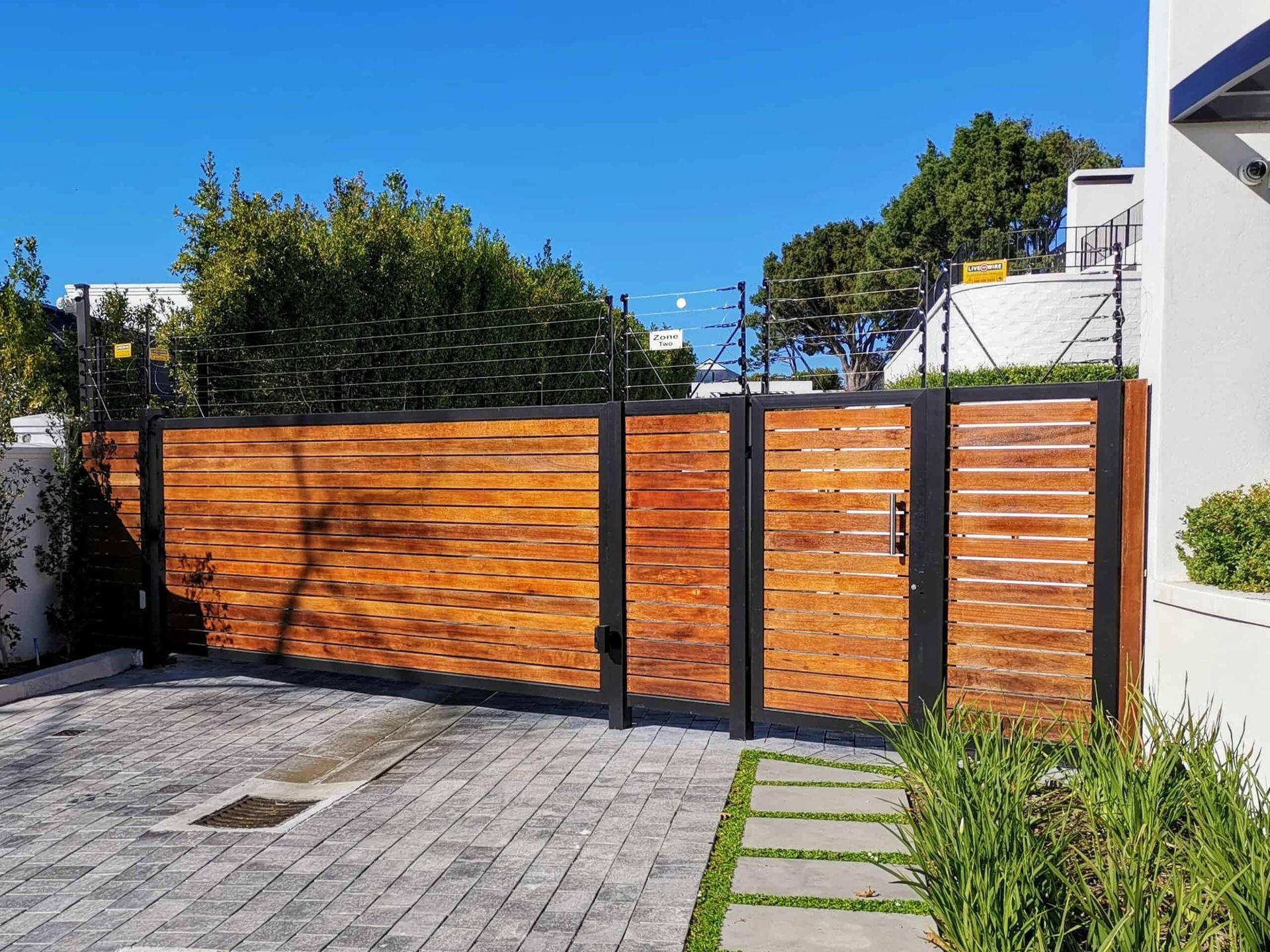 Aged wooden fence near new lumber boards.