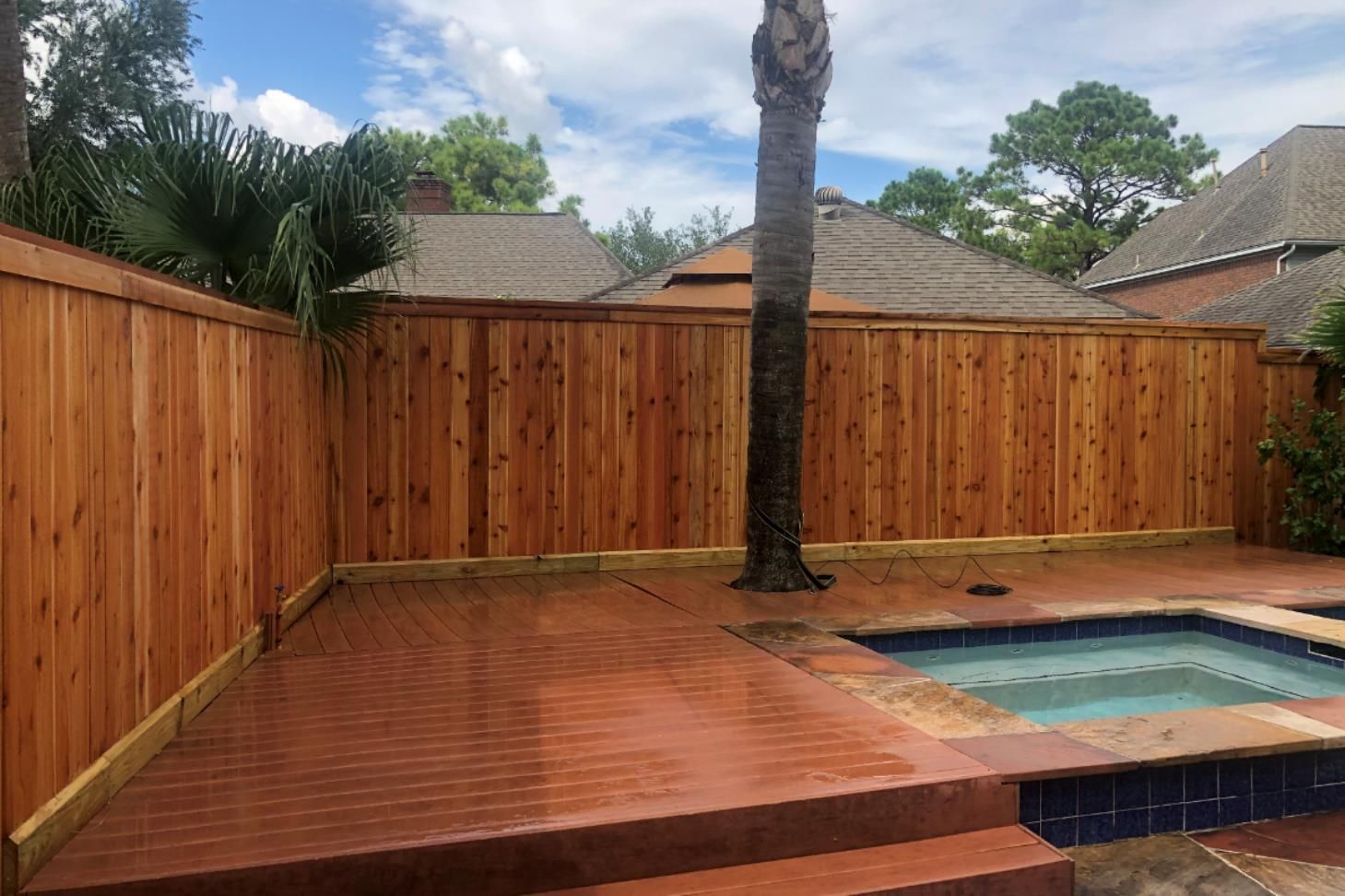 Aged wooden fence near new lumber boards.