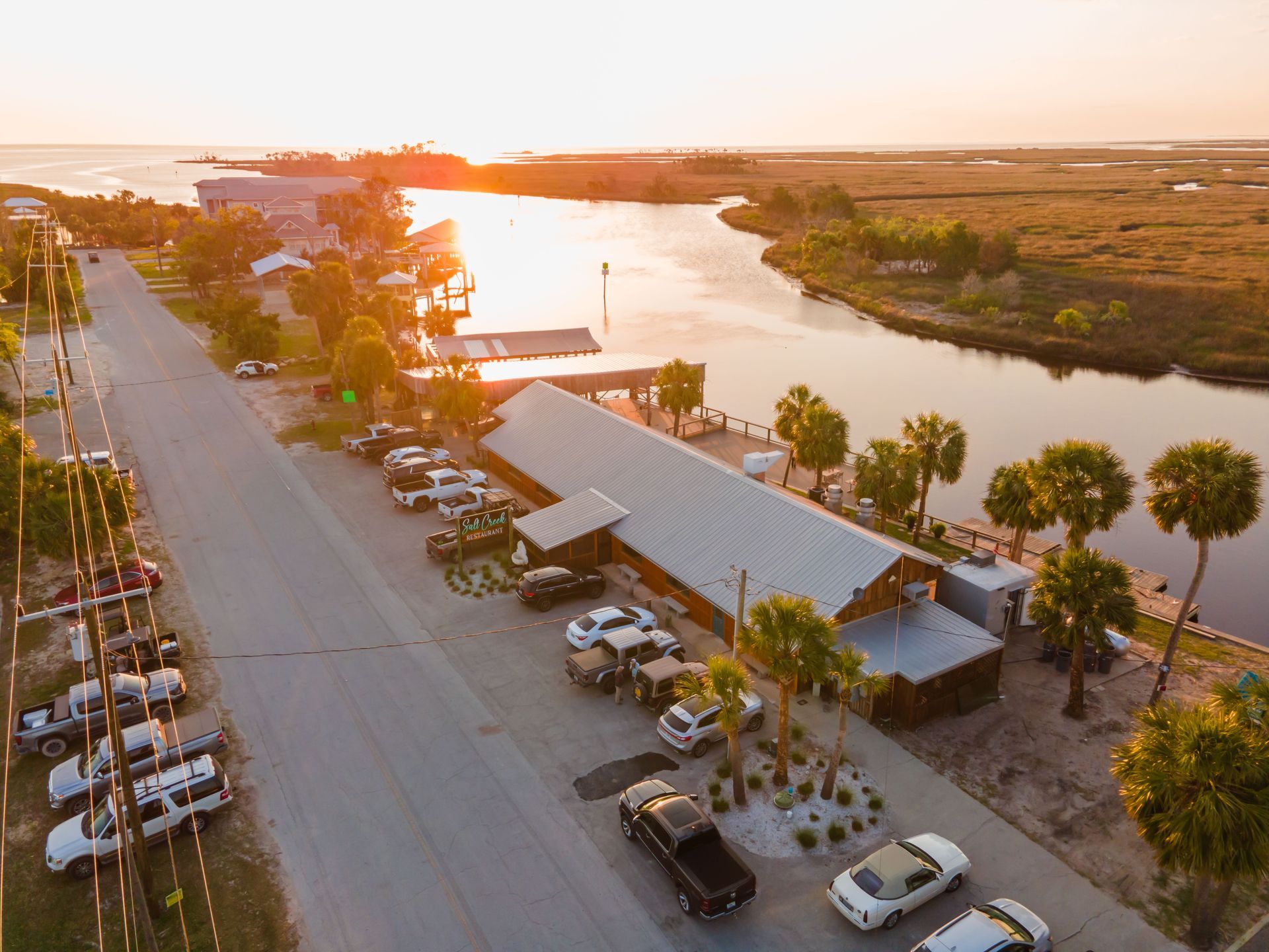 An aerial view of a parking lot next to a river.