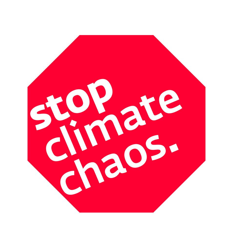 Red stop sign with white text reading “stop climate chaos.”