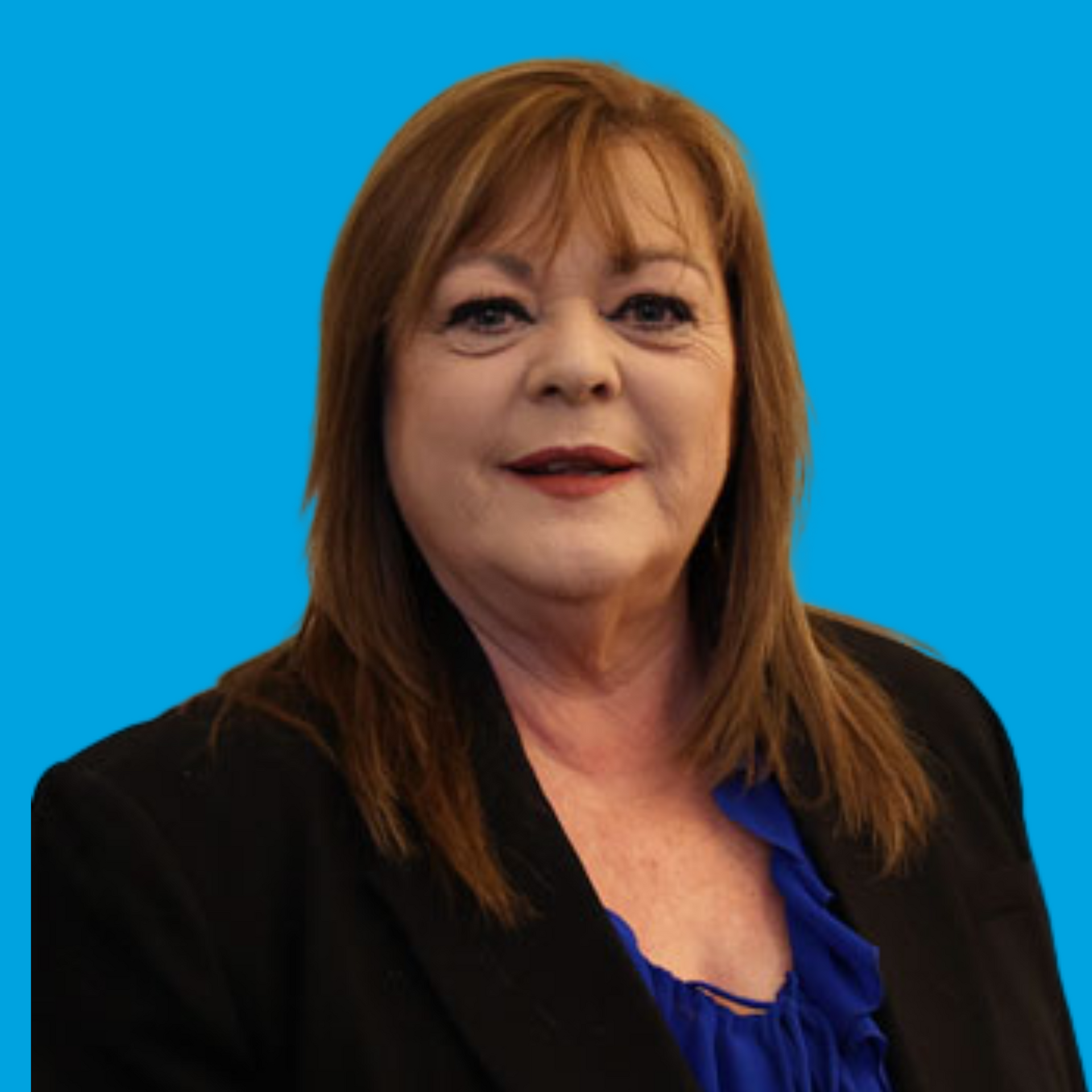 Portrait of a woman in a black blazer and blue top against a bright blue background