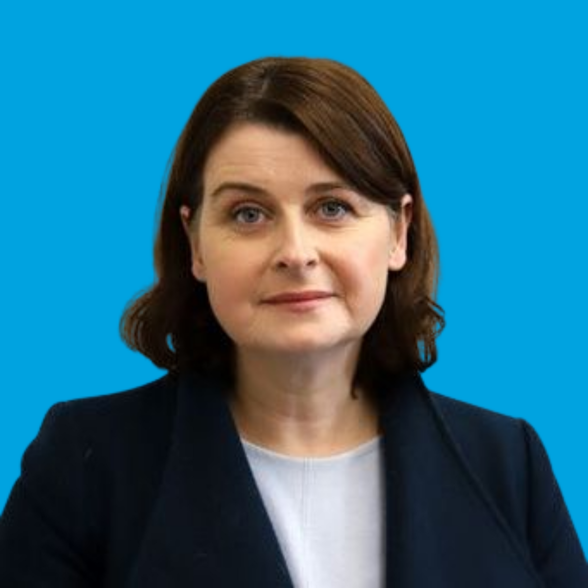 Portrait of a woman in a dark blazer against a bright blue background