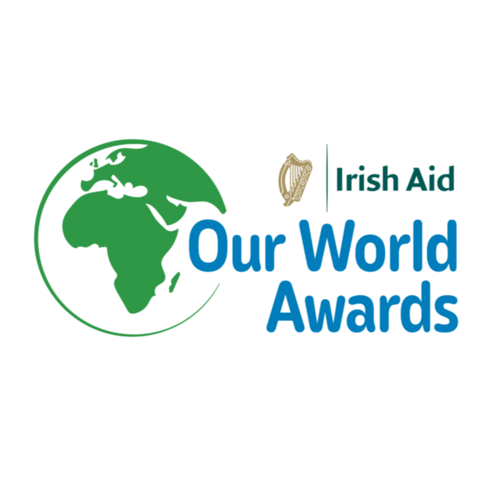 Irish Aid Our World Awards logo with green globe and blue text on white background