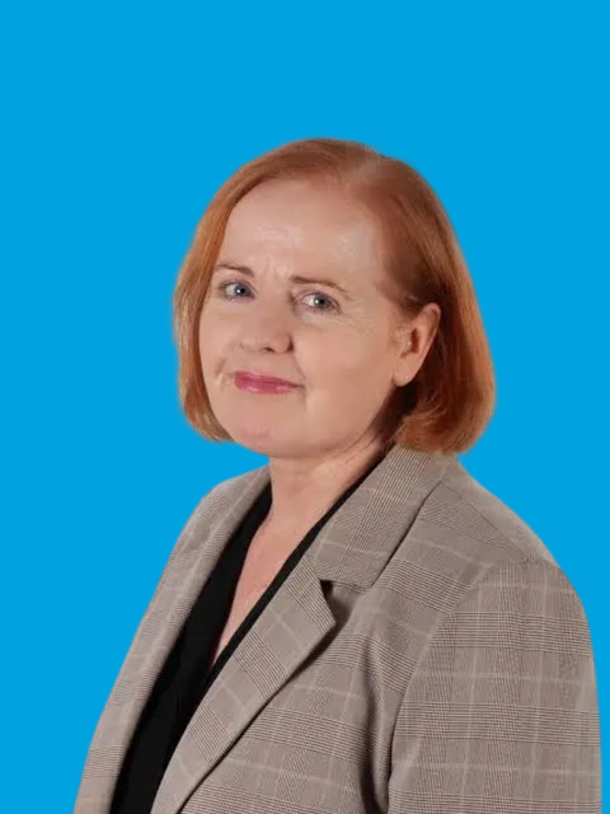 Smiling woman in a suit against a bright blue background