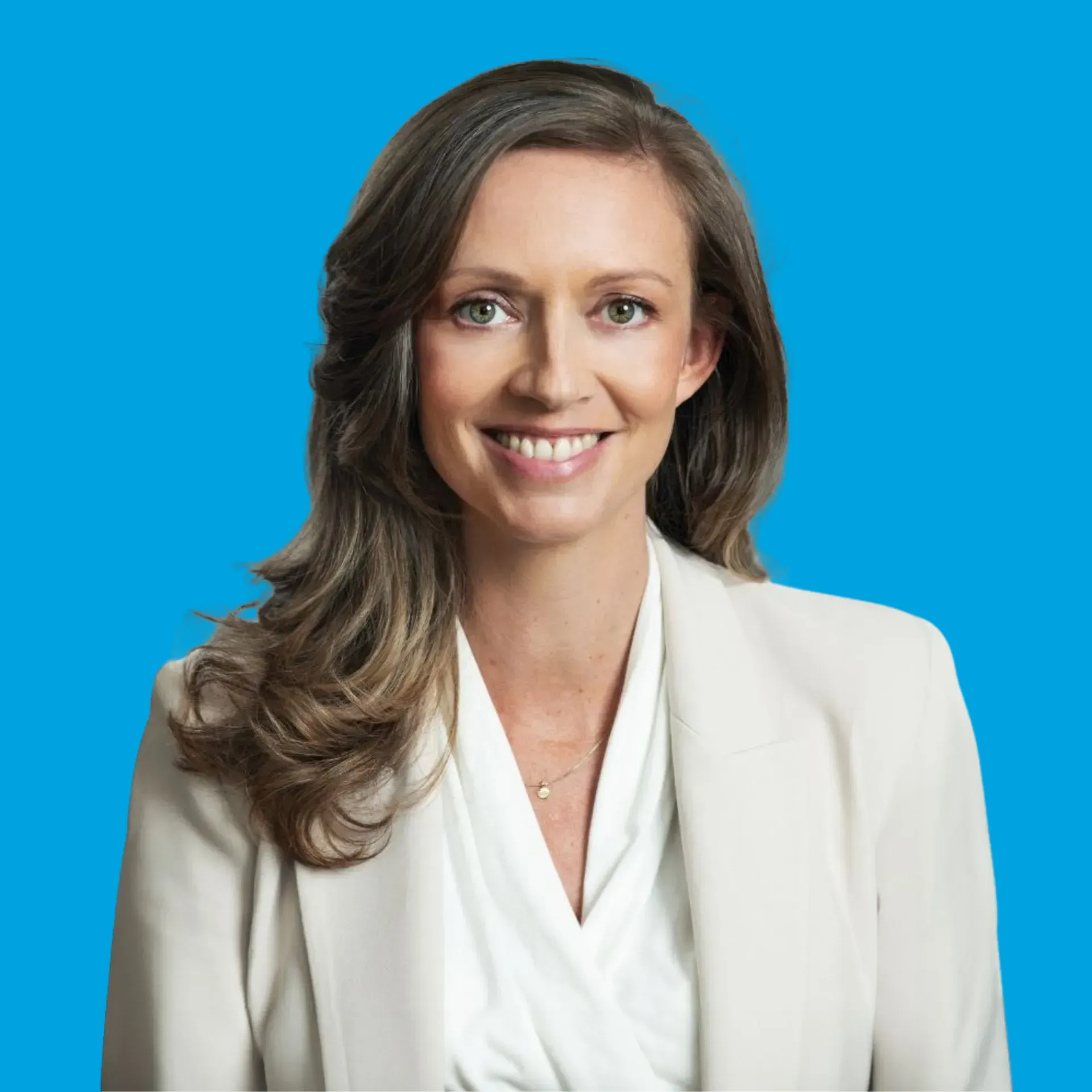 Smiling professional woman in a white blazer against a blue background