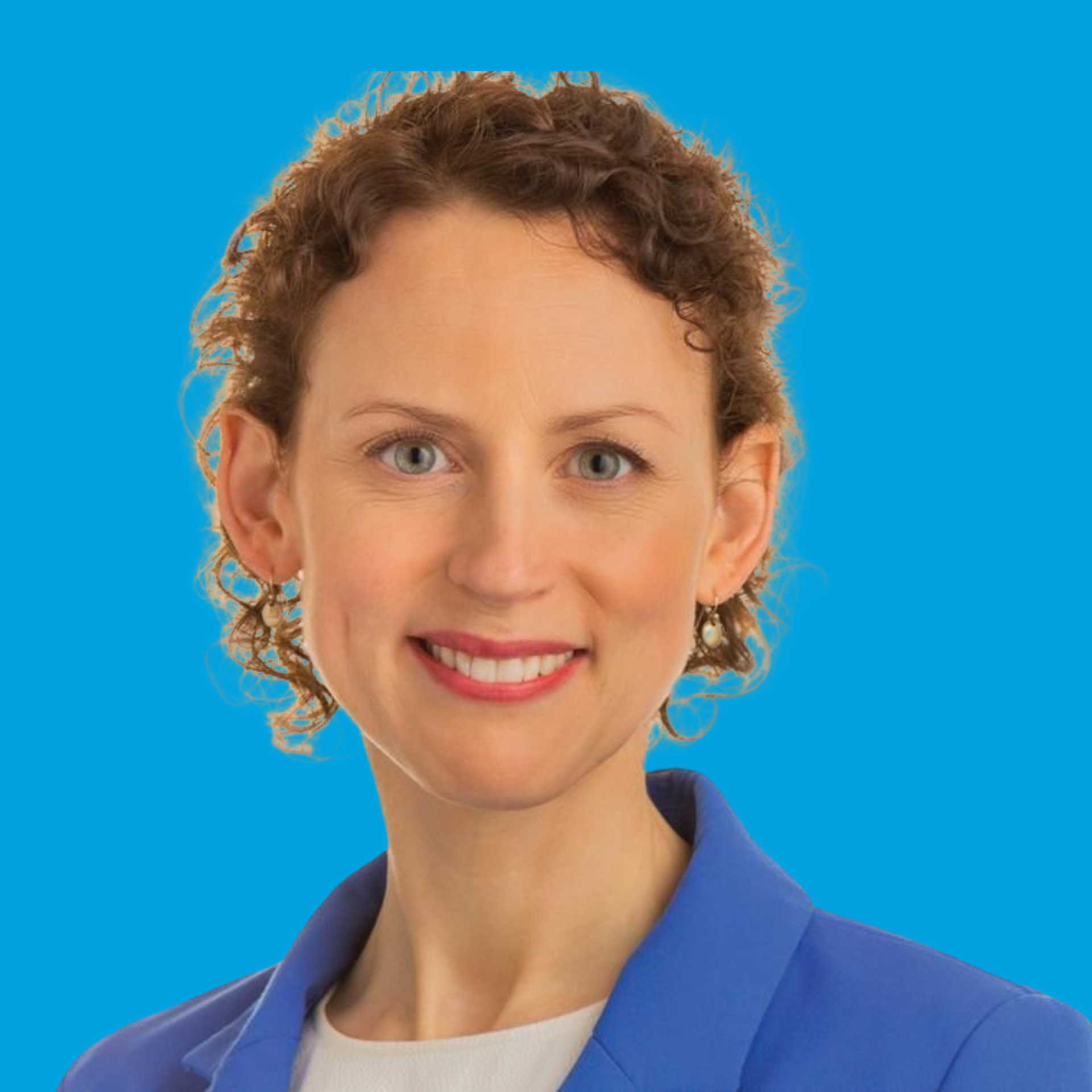 Portrait of a smiling person in a blue blazer against a bright blue background