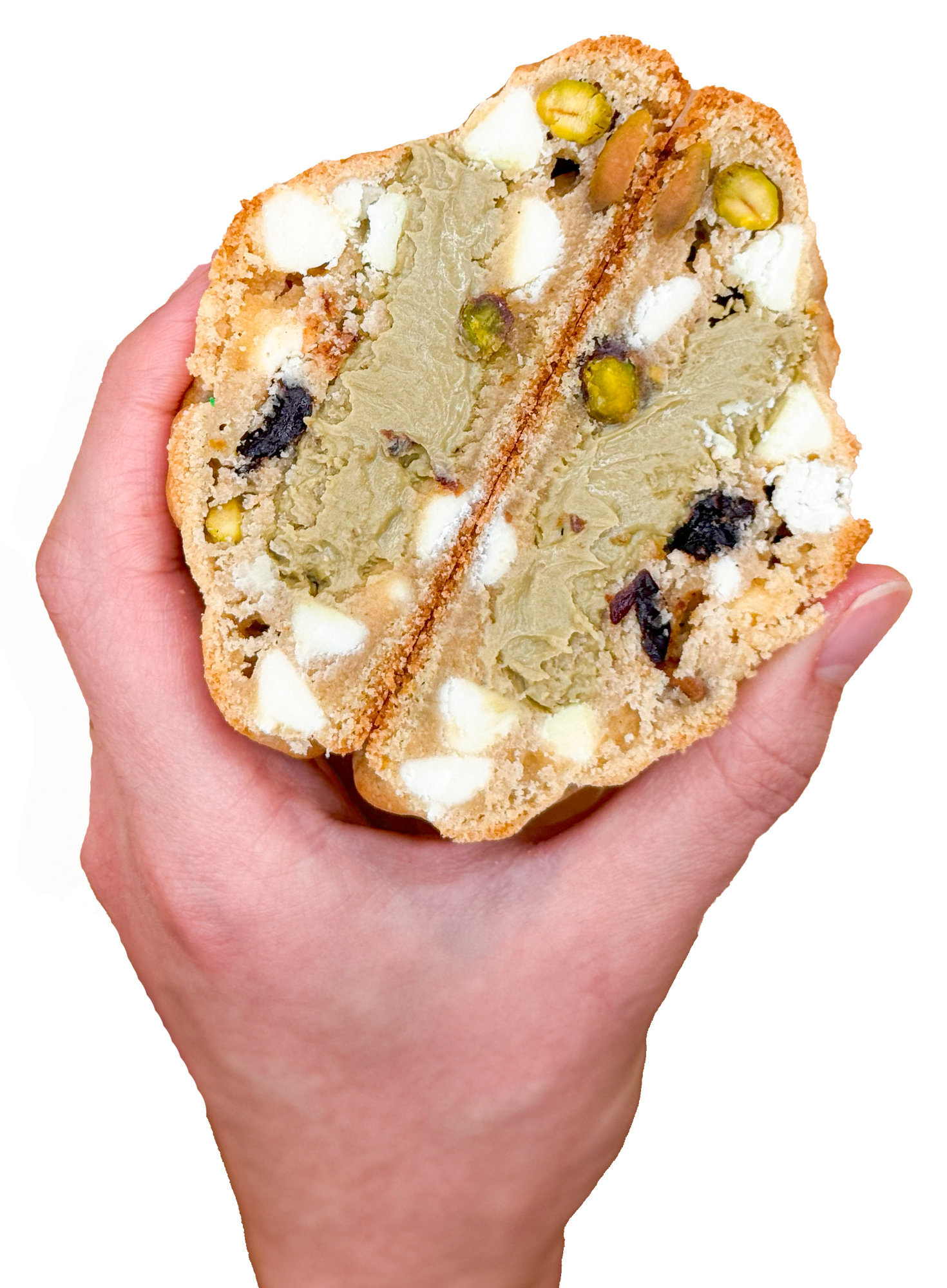 A hand is holding a cookie that is cut in half