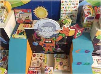 A cartoon boy in a space suit is standing in front of a display of toys.