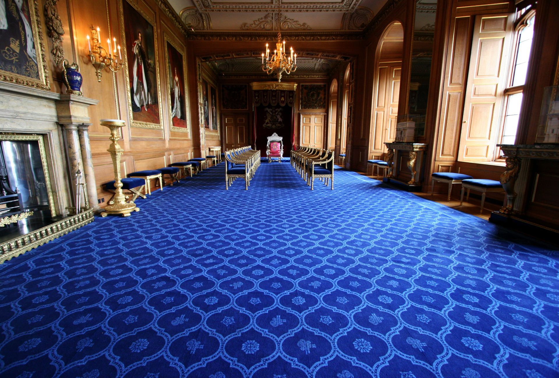 A large room with a blue carpet and a fireplace