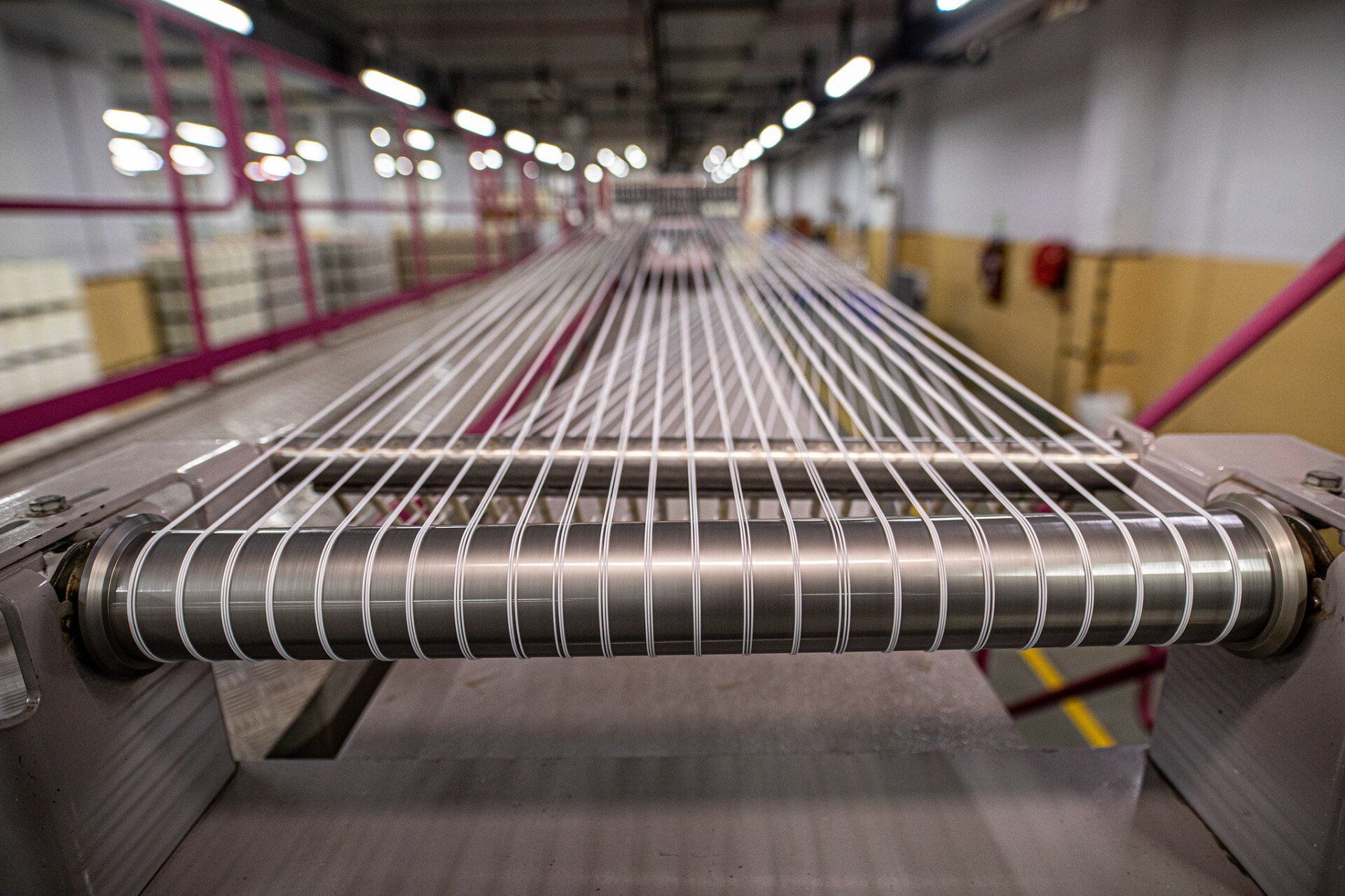A conveyor belt with a bunch of wires on it in a factory.