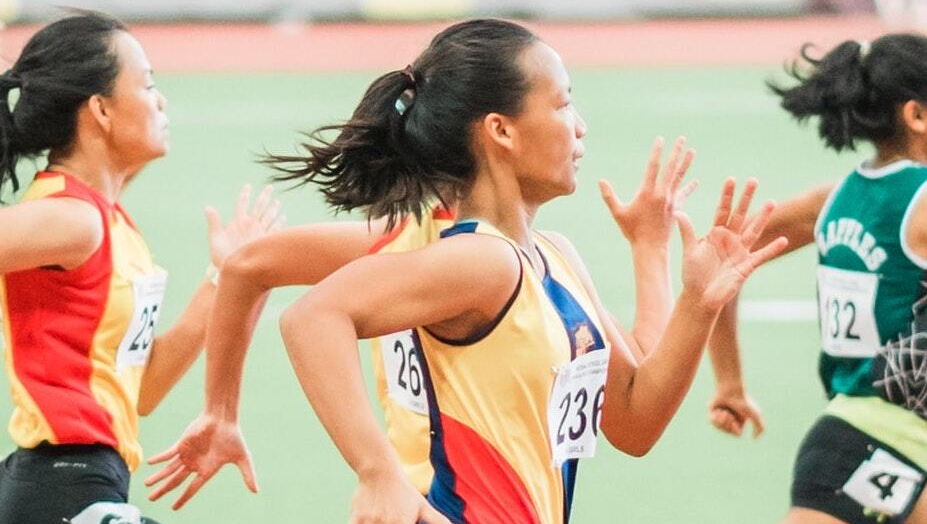 A group of young women are running on a track.
