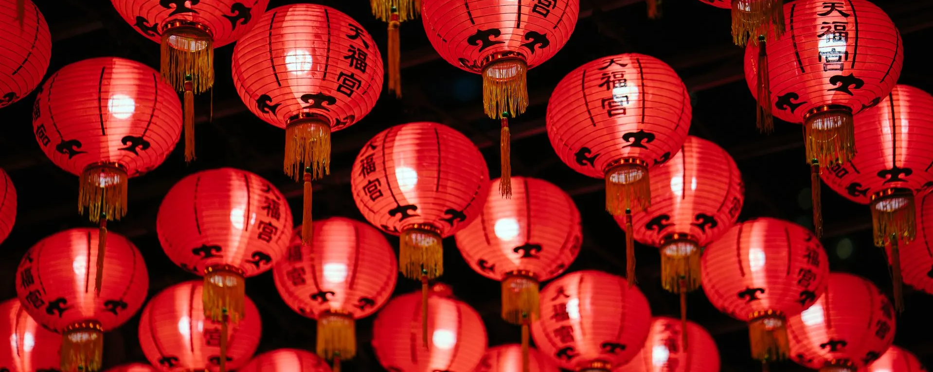 A bunch of red lanterns are hanging from the ceiling.
