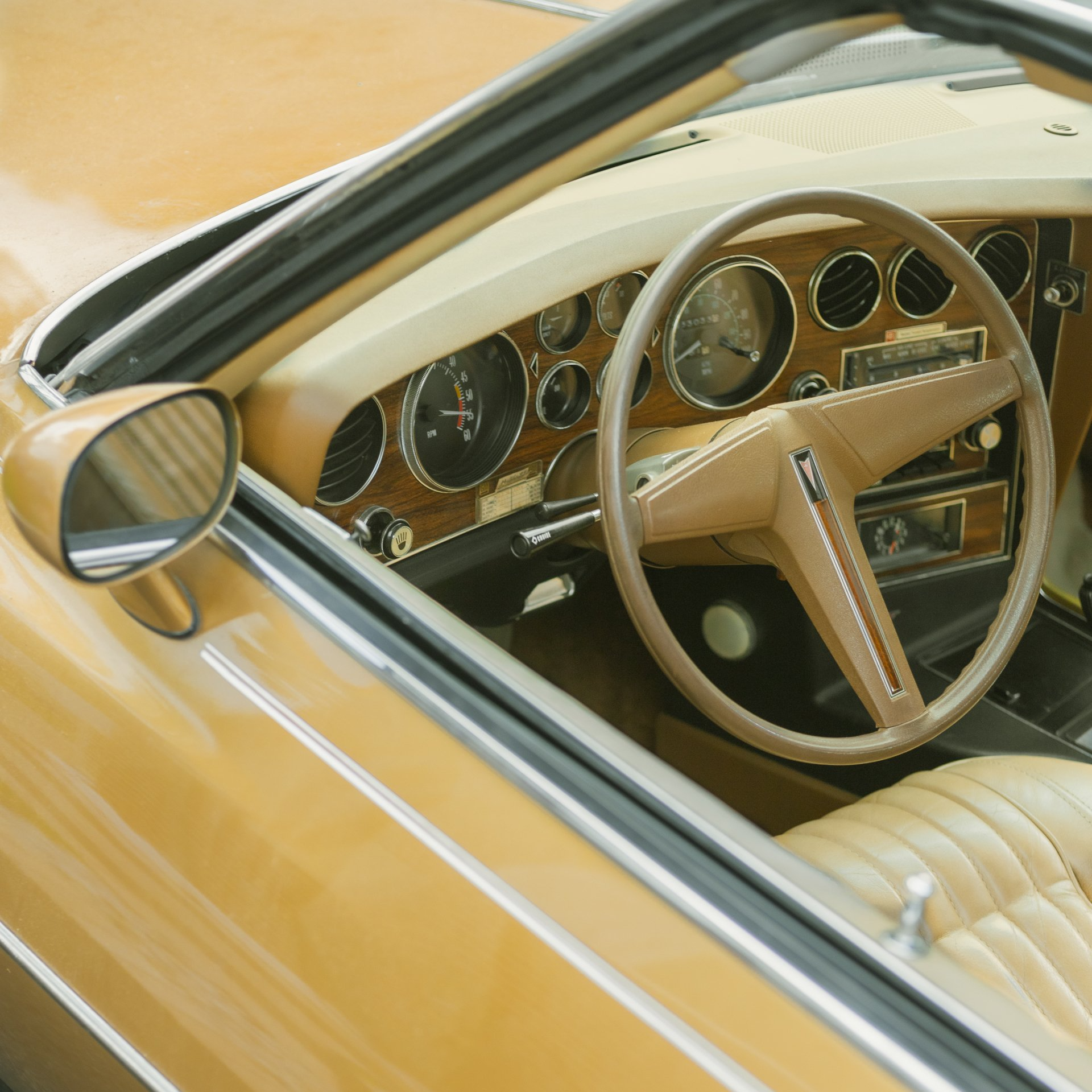 A close up of a car dashboard with a steering wheel
