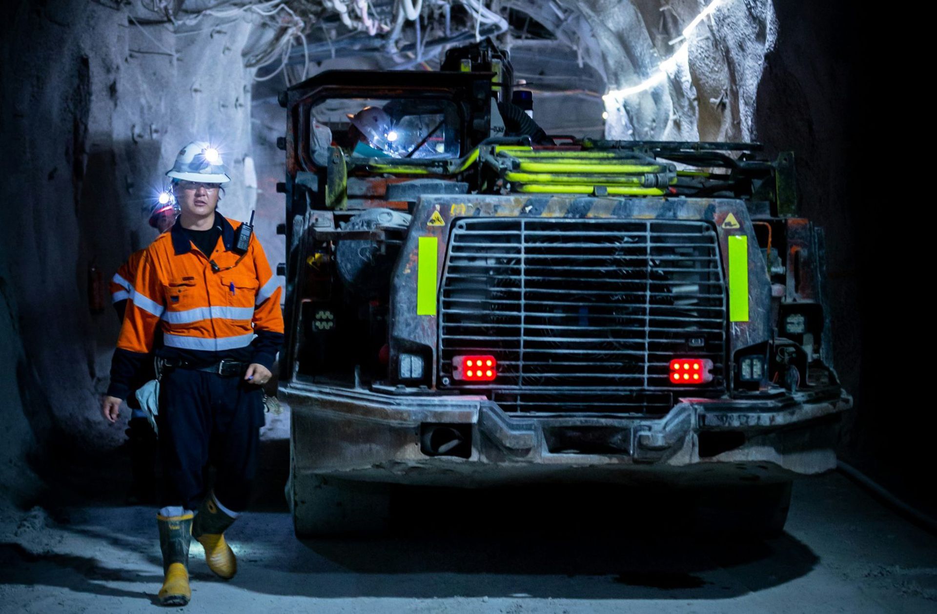 Underground photo of mining operations with miner and equipment