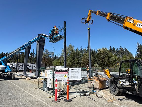 Construction crews add steel I-beams as part of primary framing