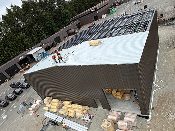 Waterproof lining being added to PEMB roofing frame