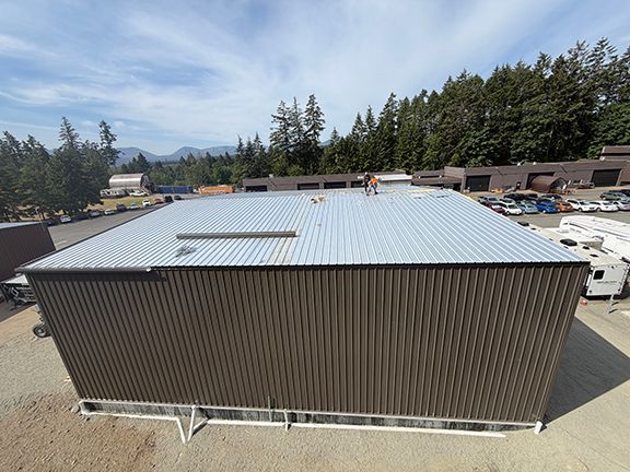 Pre-engineered metal building with roofing panels added