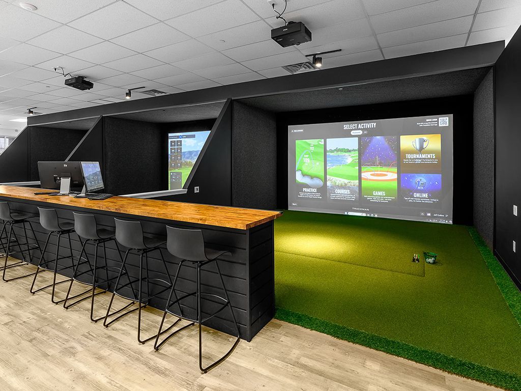Example of a indoor golf swing bay with screen and mats