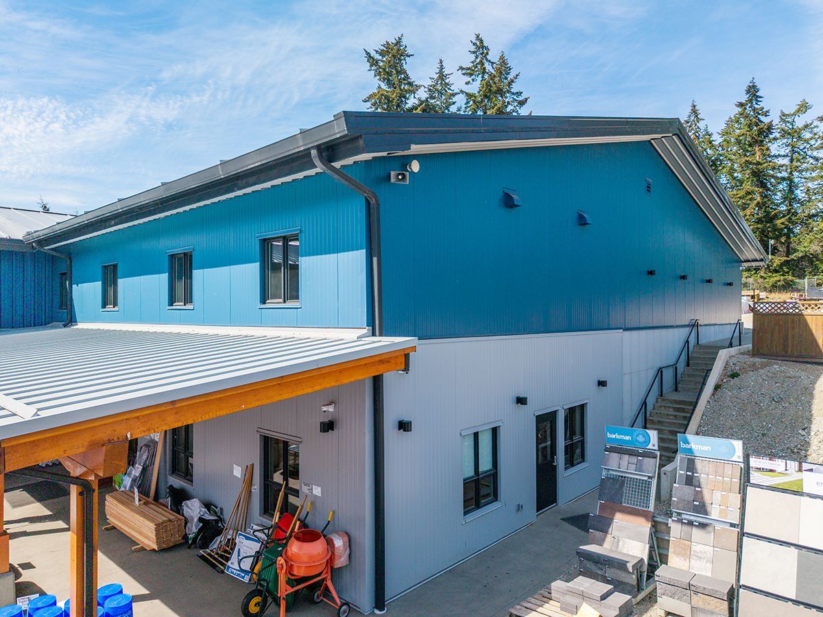Side angle shows how steel building is built into the site's hilly terrain
