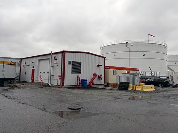 Jet fuel pump facility is located next to large storage containers at YVR.