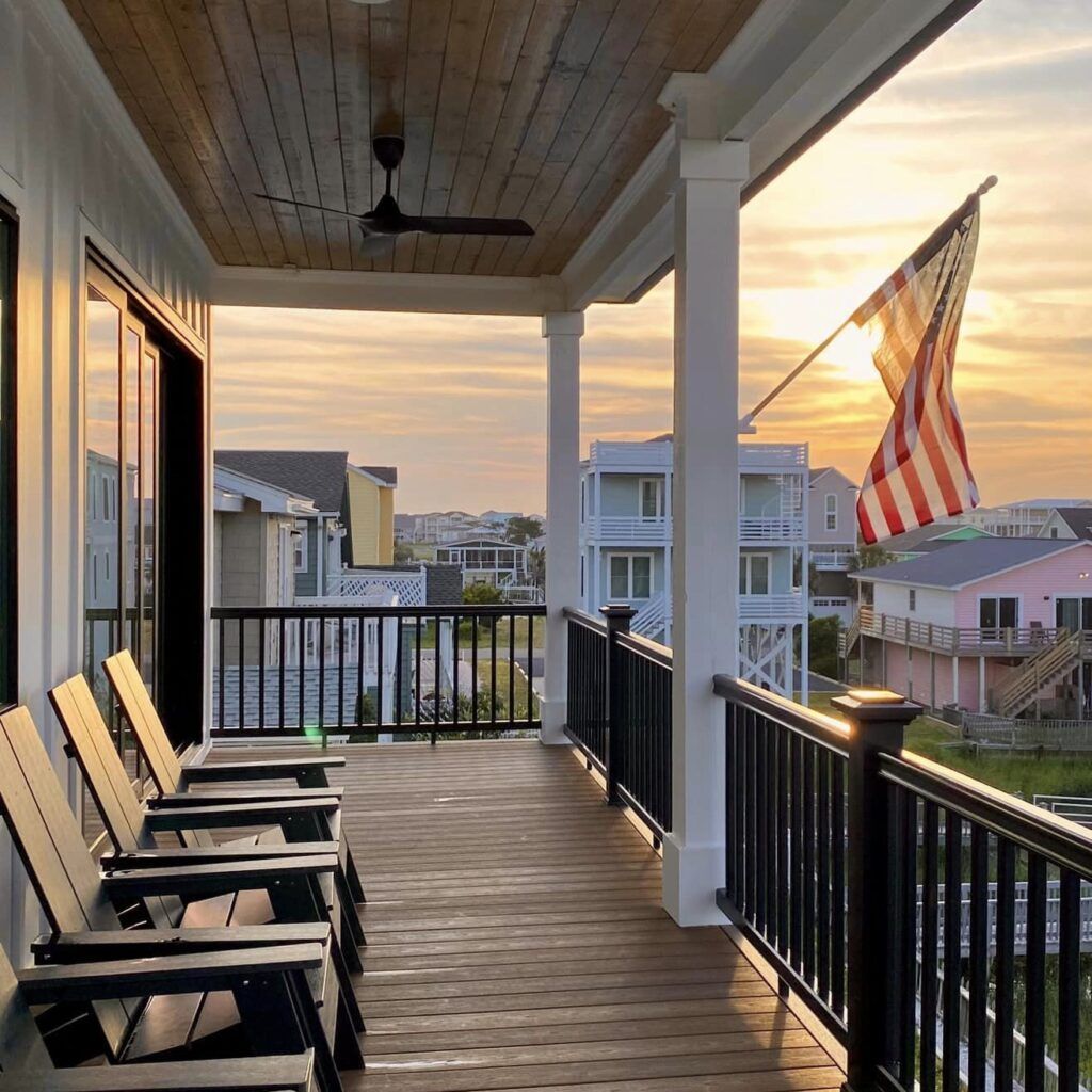 Porch With Rocking Chairs And Sunset View
