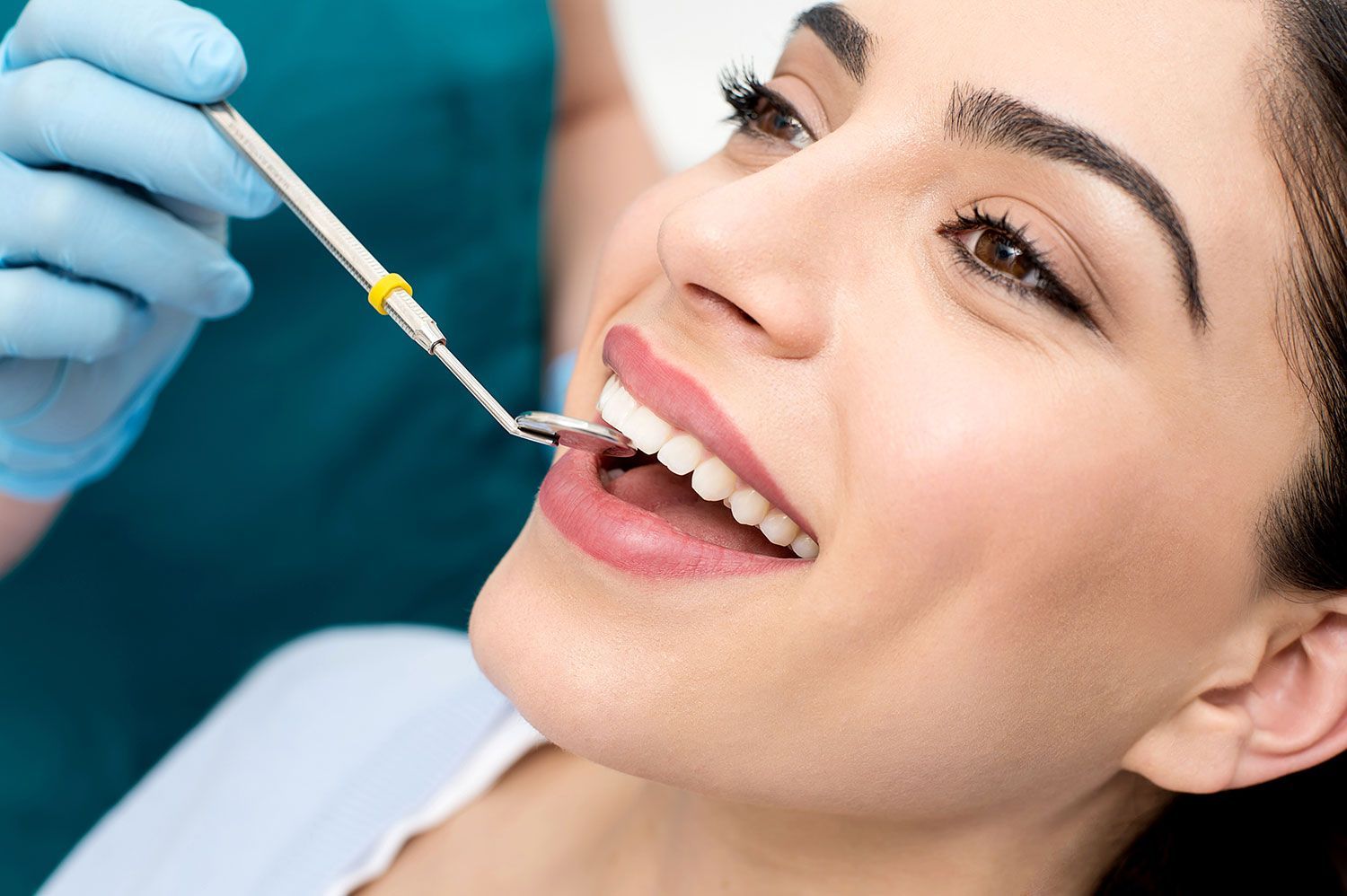 woman having her teeth inspected by dentist