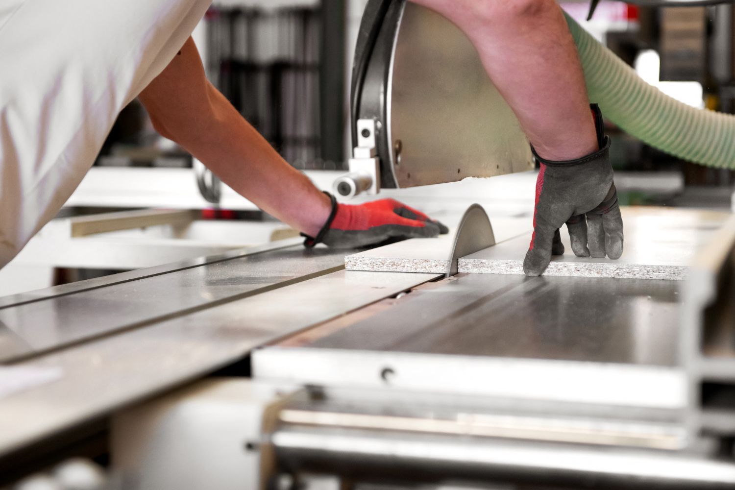 A person is cutting a piece of wood with a circular saw.