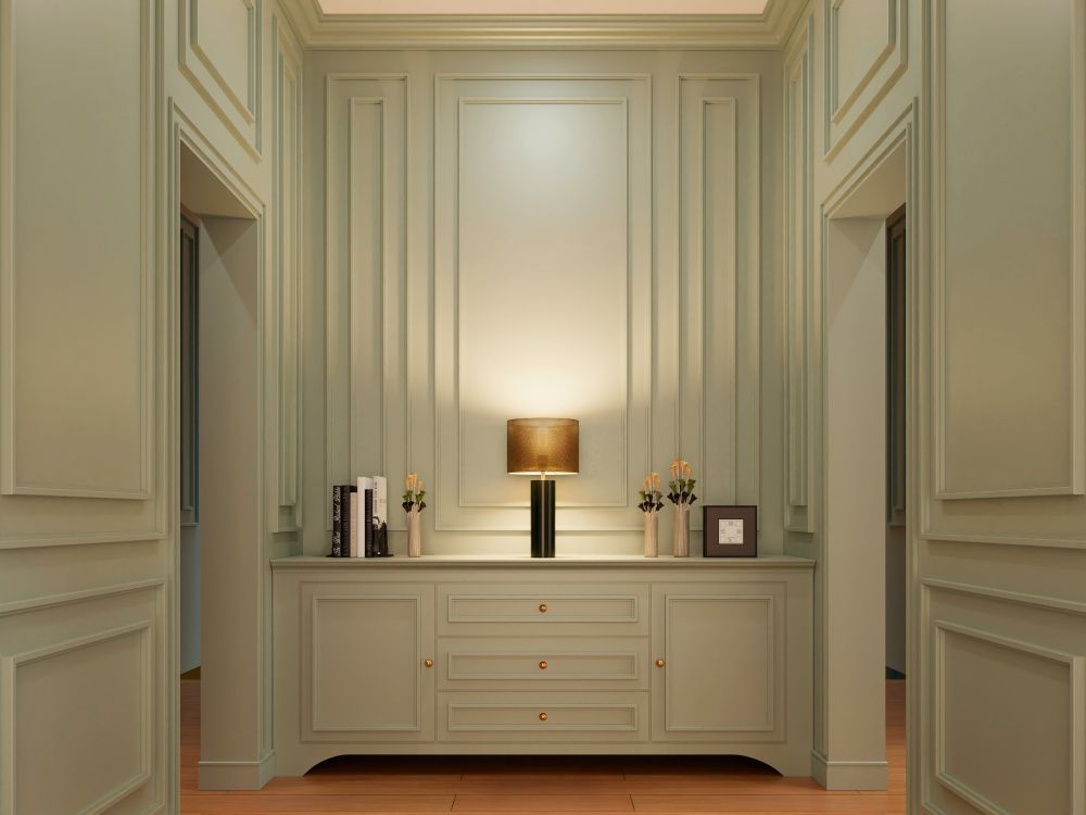 A kitchen with white cabinets and a large island in the middle.