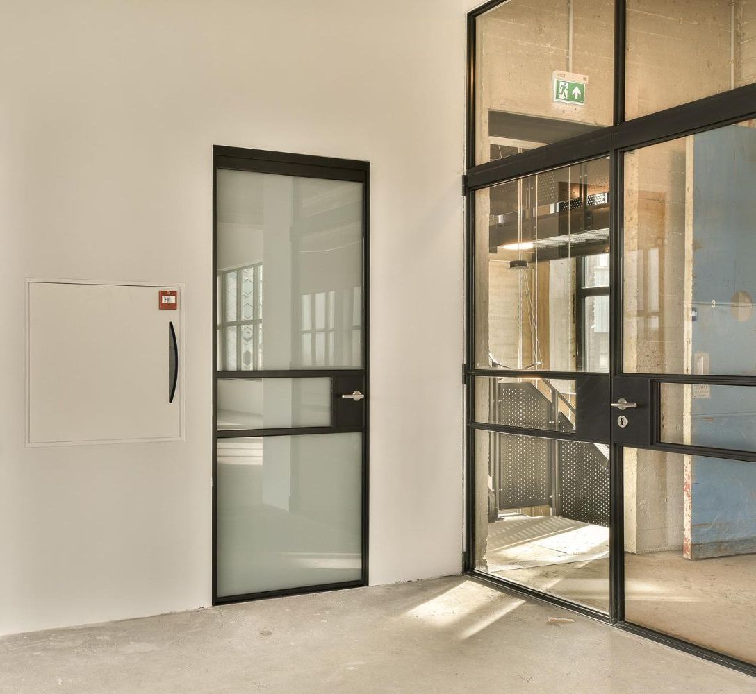 A row of glass doors leading to a building.