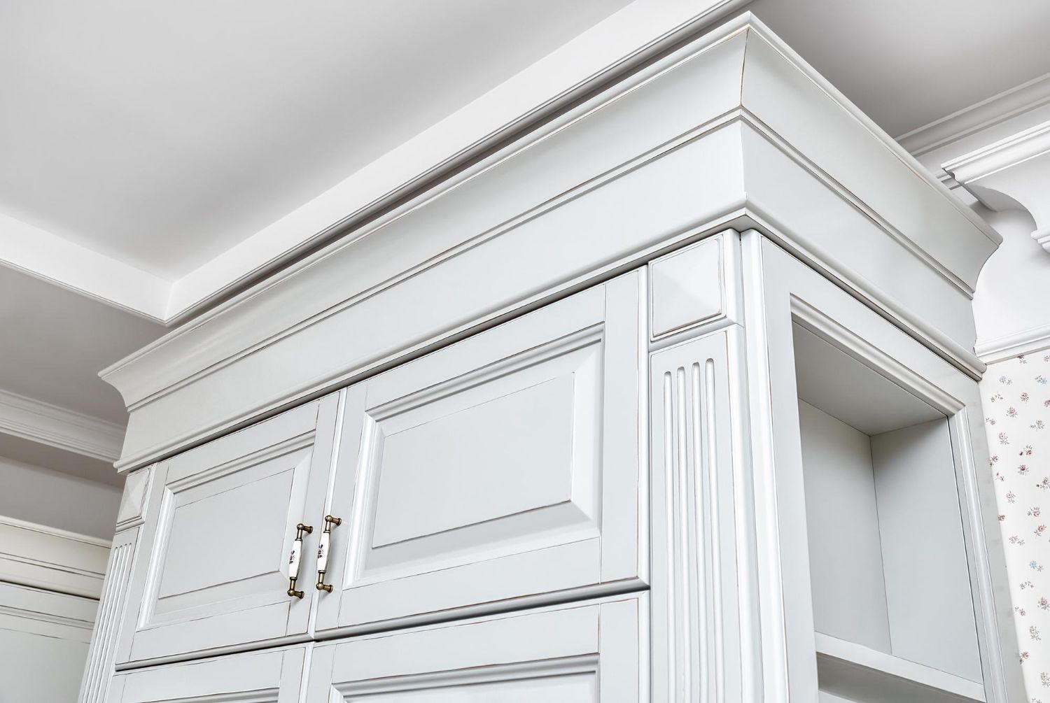 A close up of a white cabinet with a crown molding.