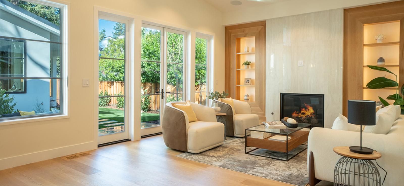A living room with a couch , table , chairs and a kitchen.