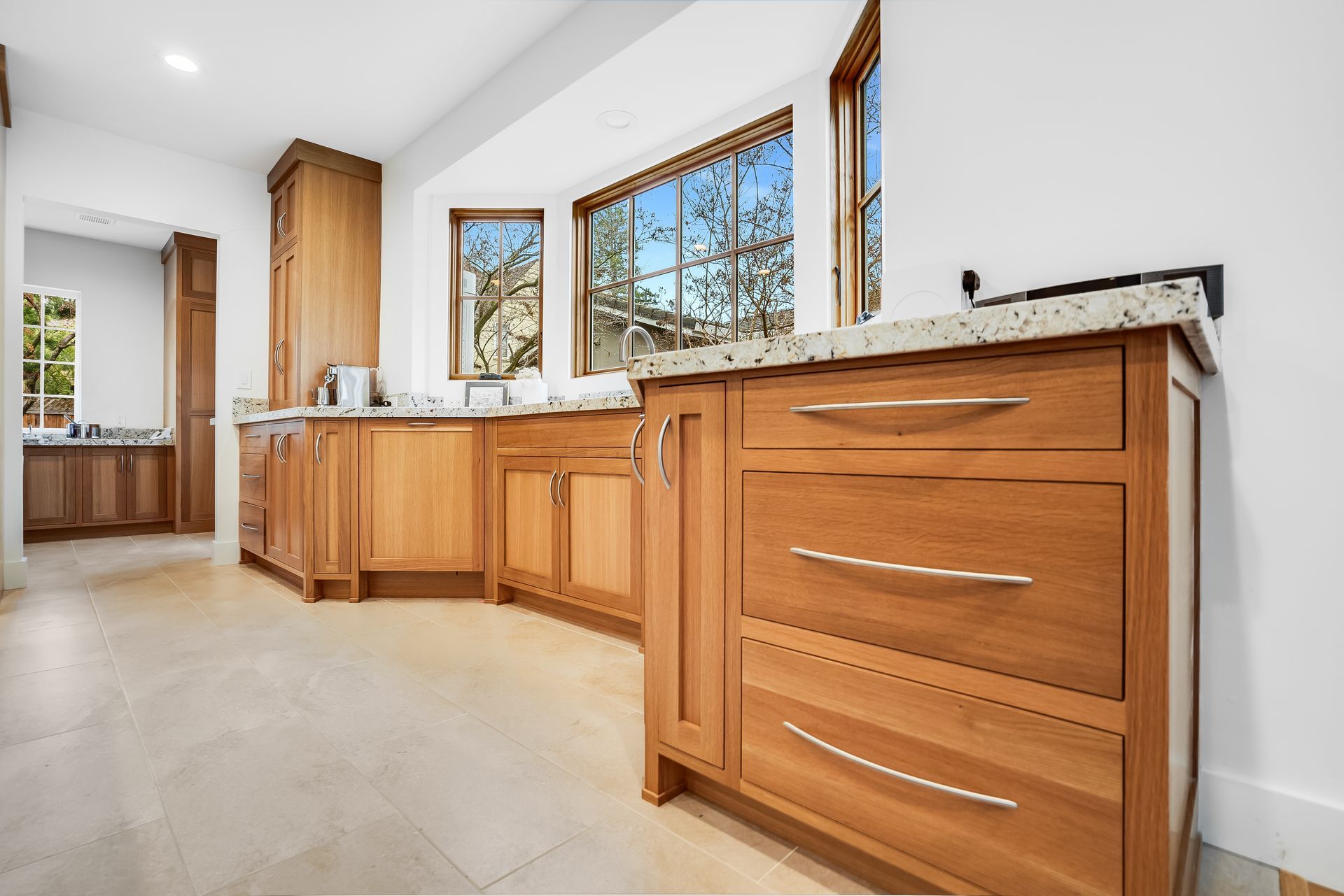 A kitchen with wooden cabinets and granite counter tops.