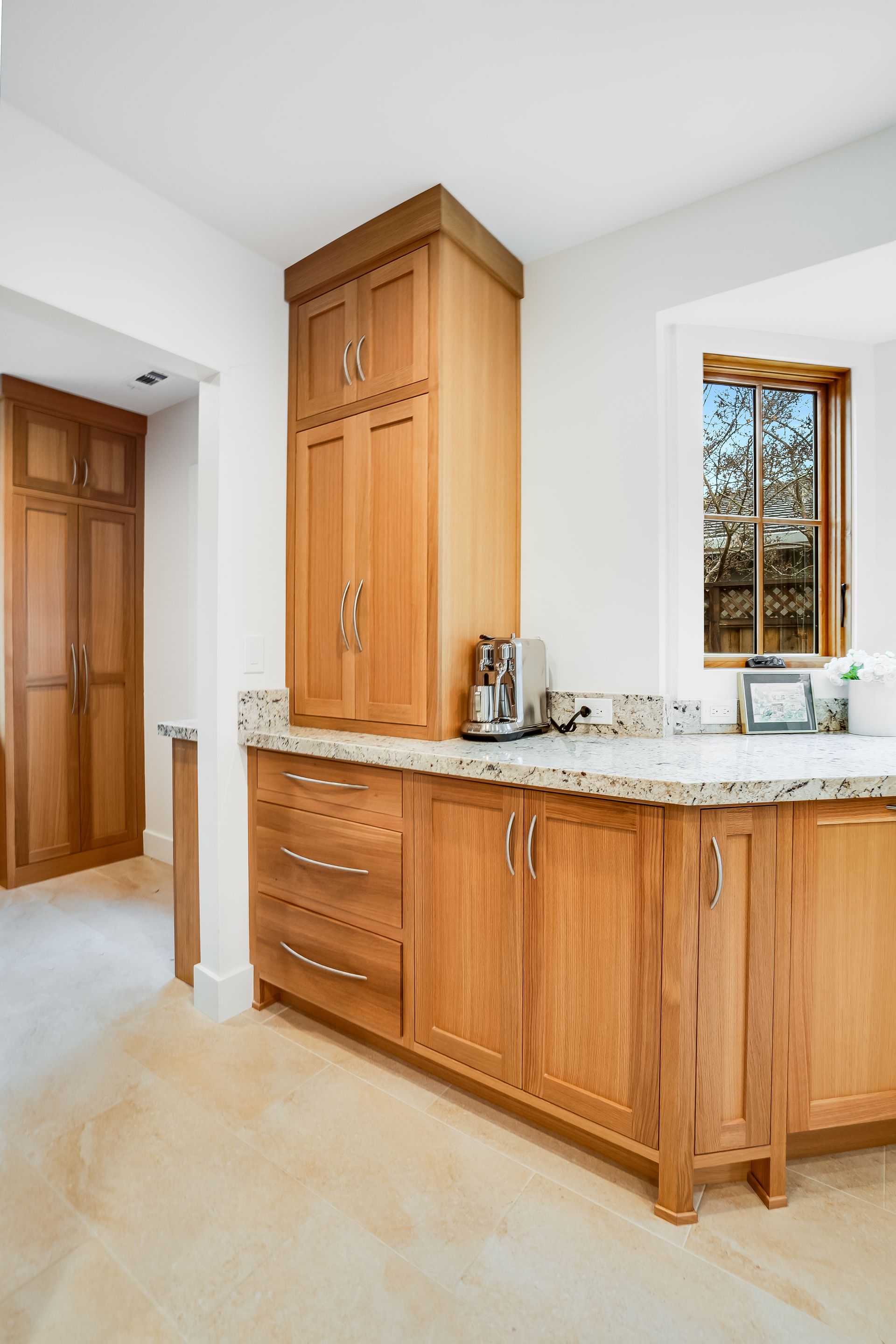 A kitchen with wooden cabinets and granite counter tops