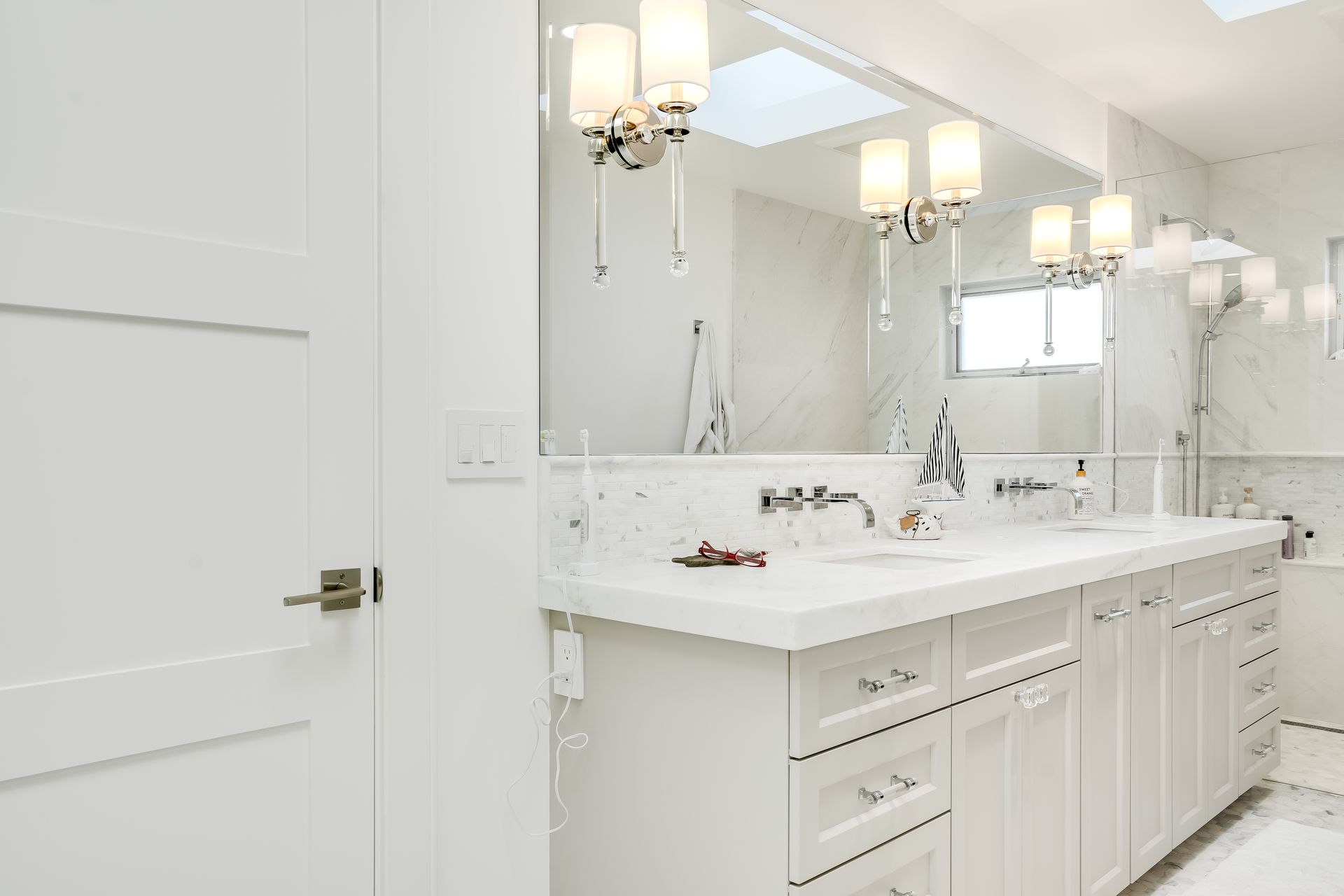 A bathroom with two sinks and a large mirror.