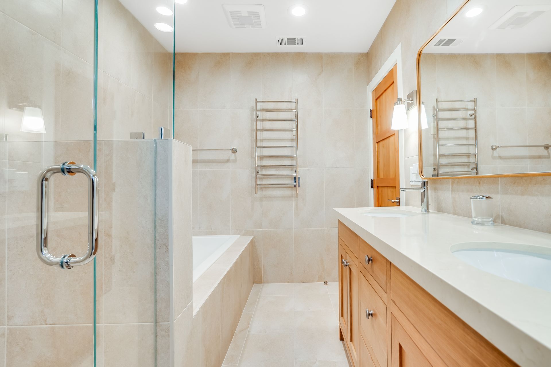 A bathroom with a walk in shower , sink , and mirror.