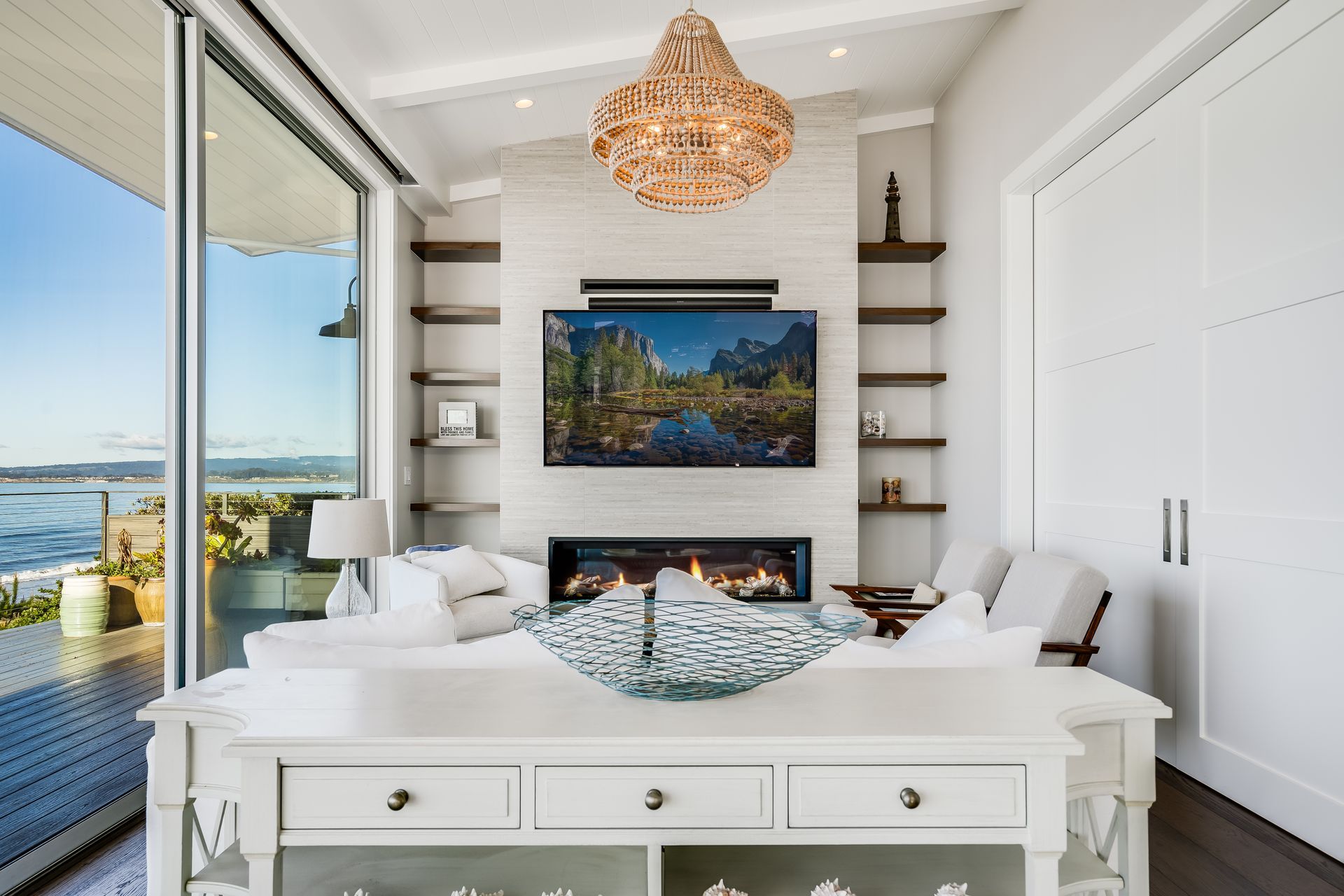 A living room with a fireplace and a flat screen tv on the wall.