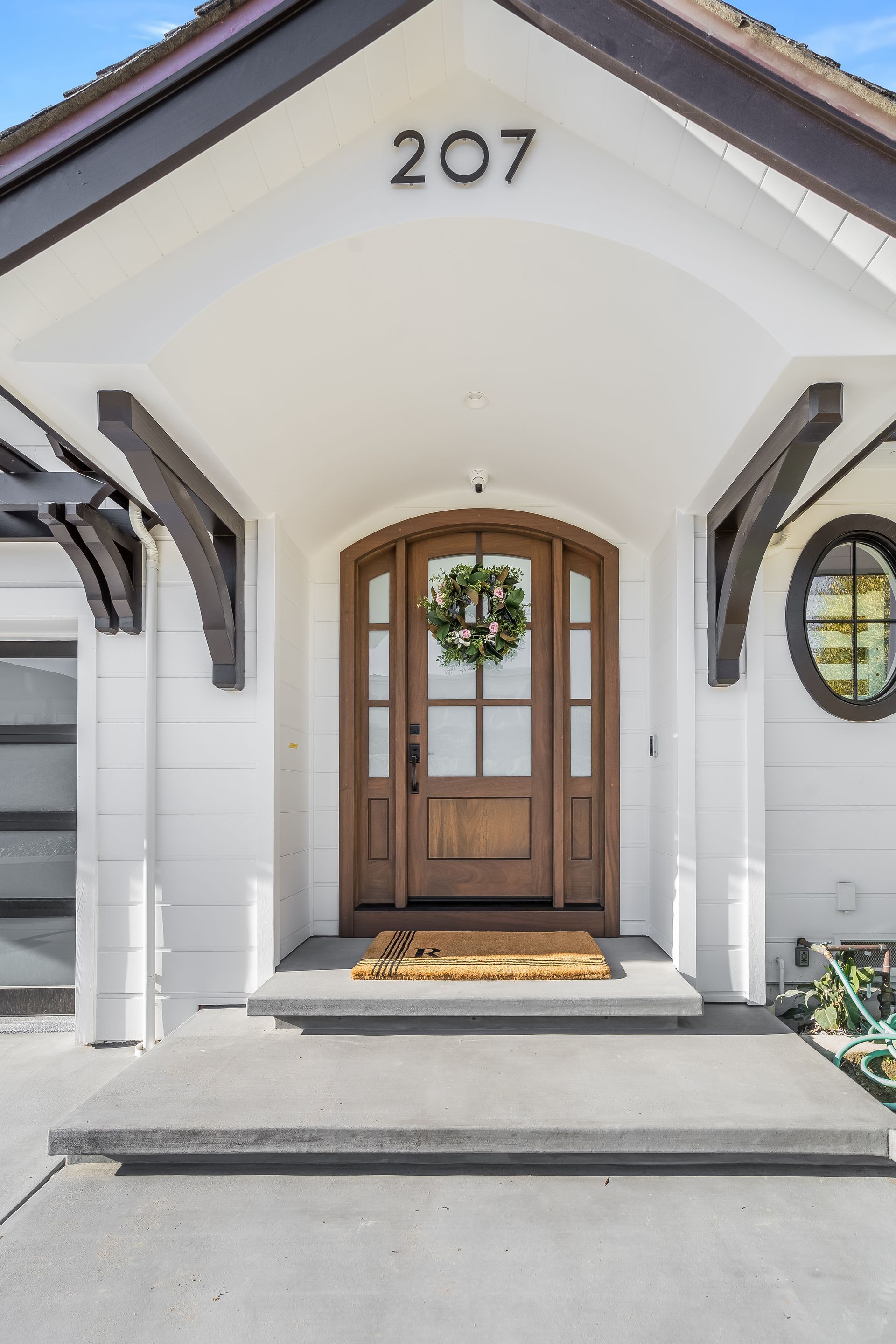 The front door of a house with the number 207 on it