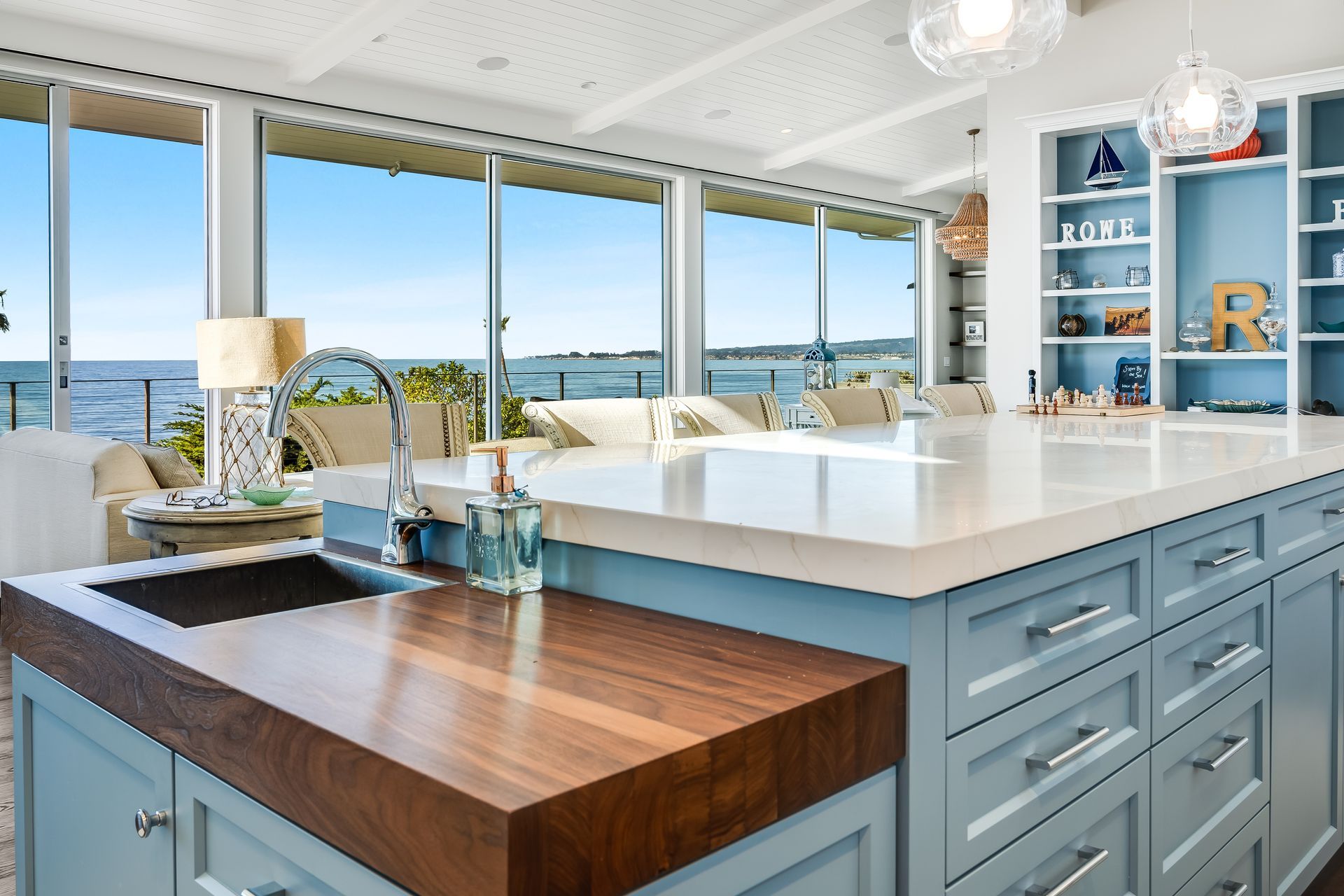 A kitchen with blue cabinets and a wooden counter top
