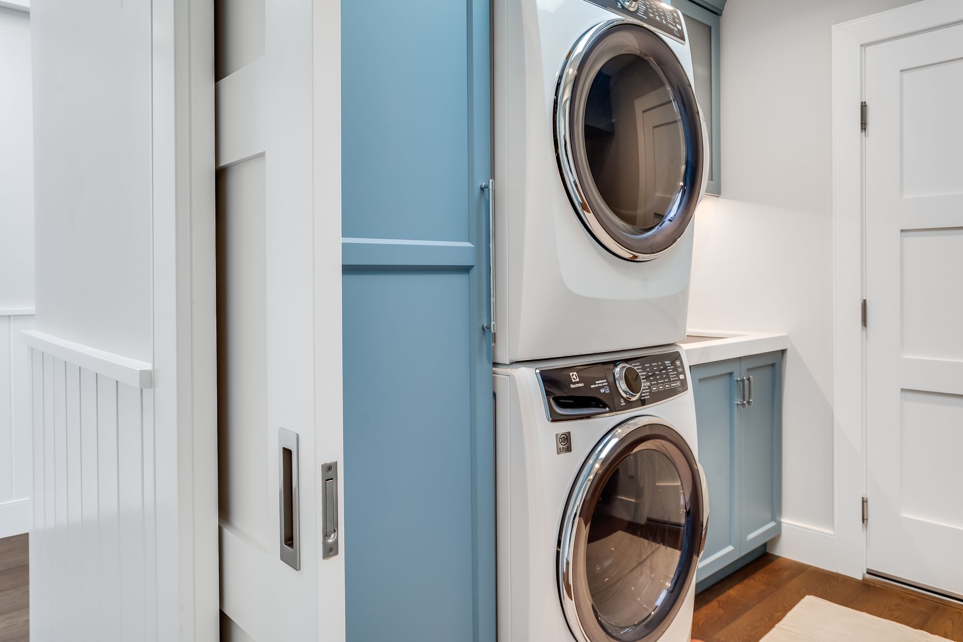 A washer and dryer are stacked on top of each other in a laundry room.