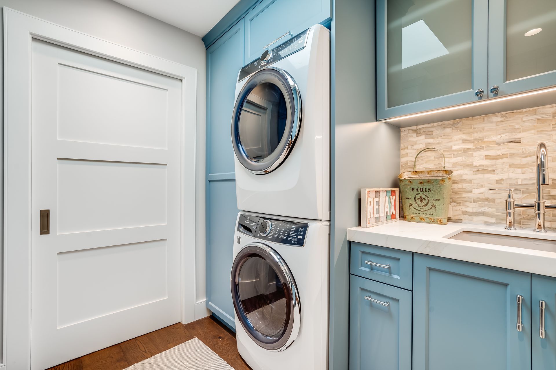 A laundry room with a washer and dryer stacked on top of each other.