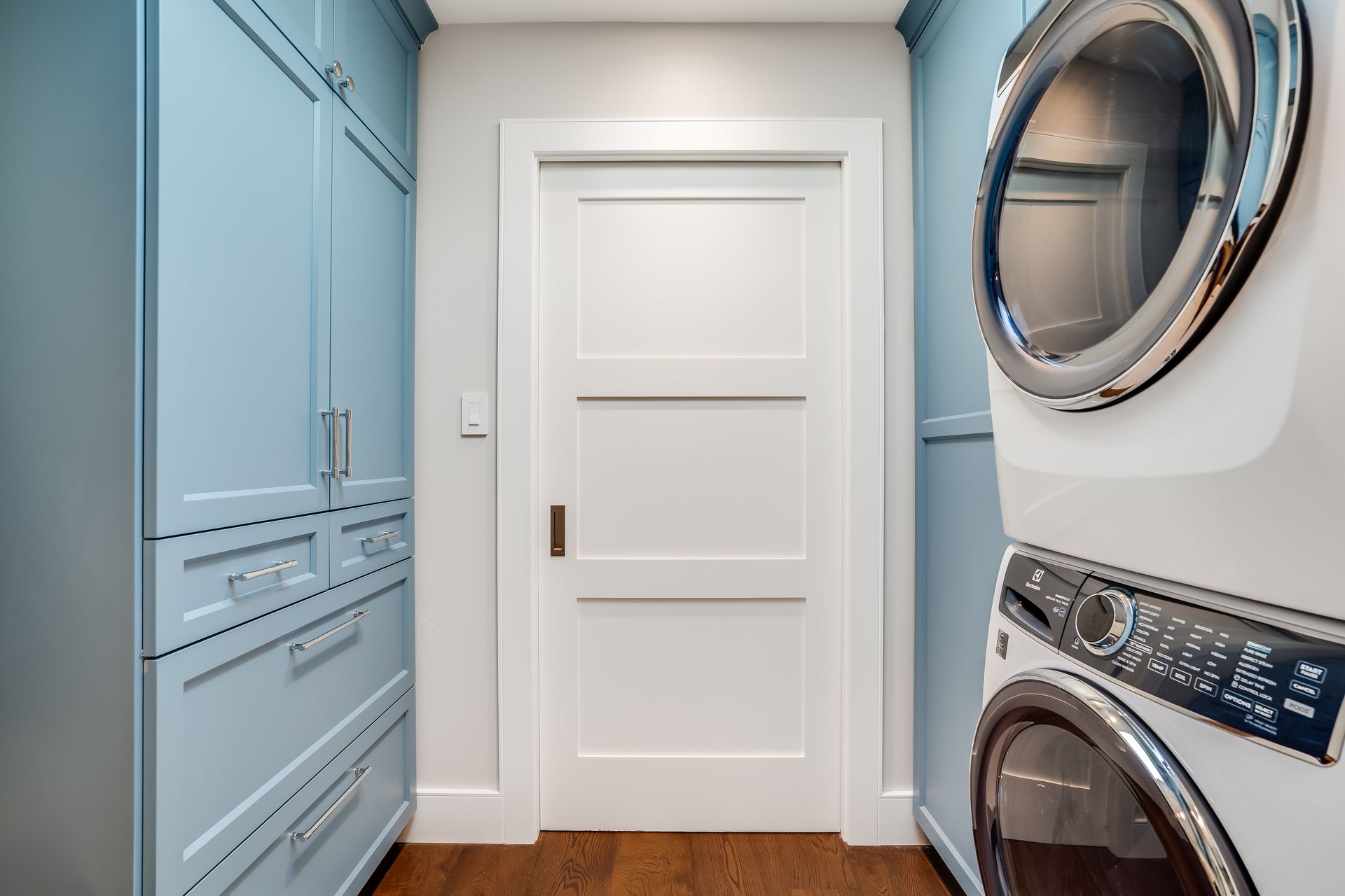 A laundry room with a washer and dryer stacked on top of each other.