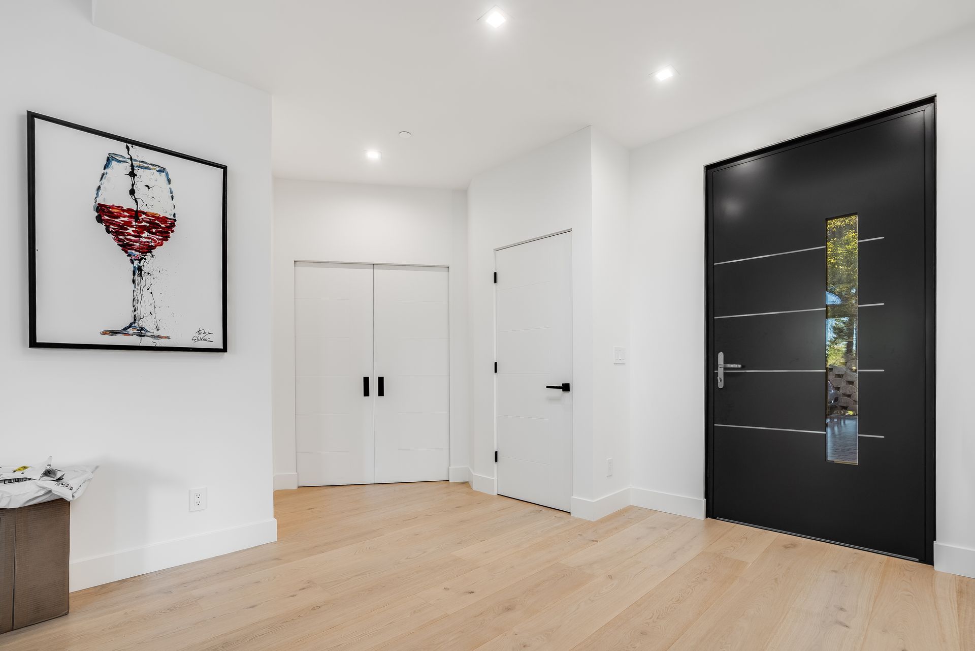 There is a painting of a glass of wine on the wall.