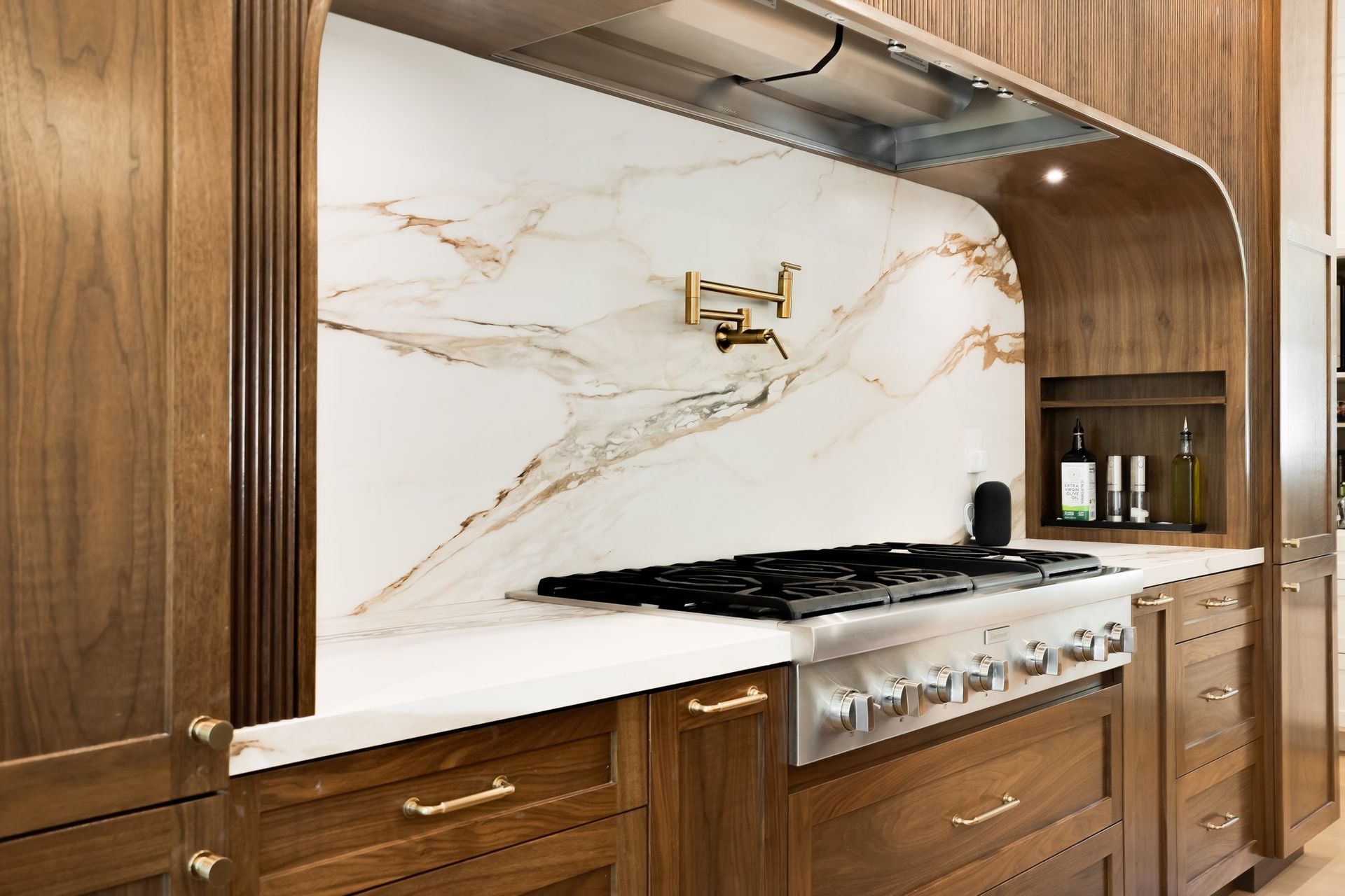 Walnut kitchen cabinetry and custom range hood at Douglass Lane
