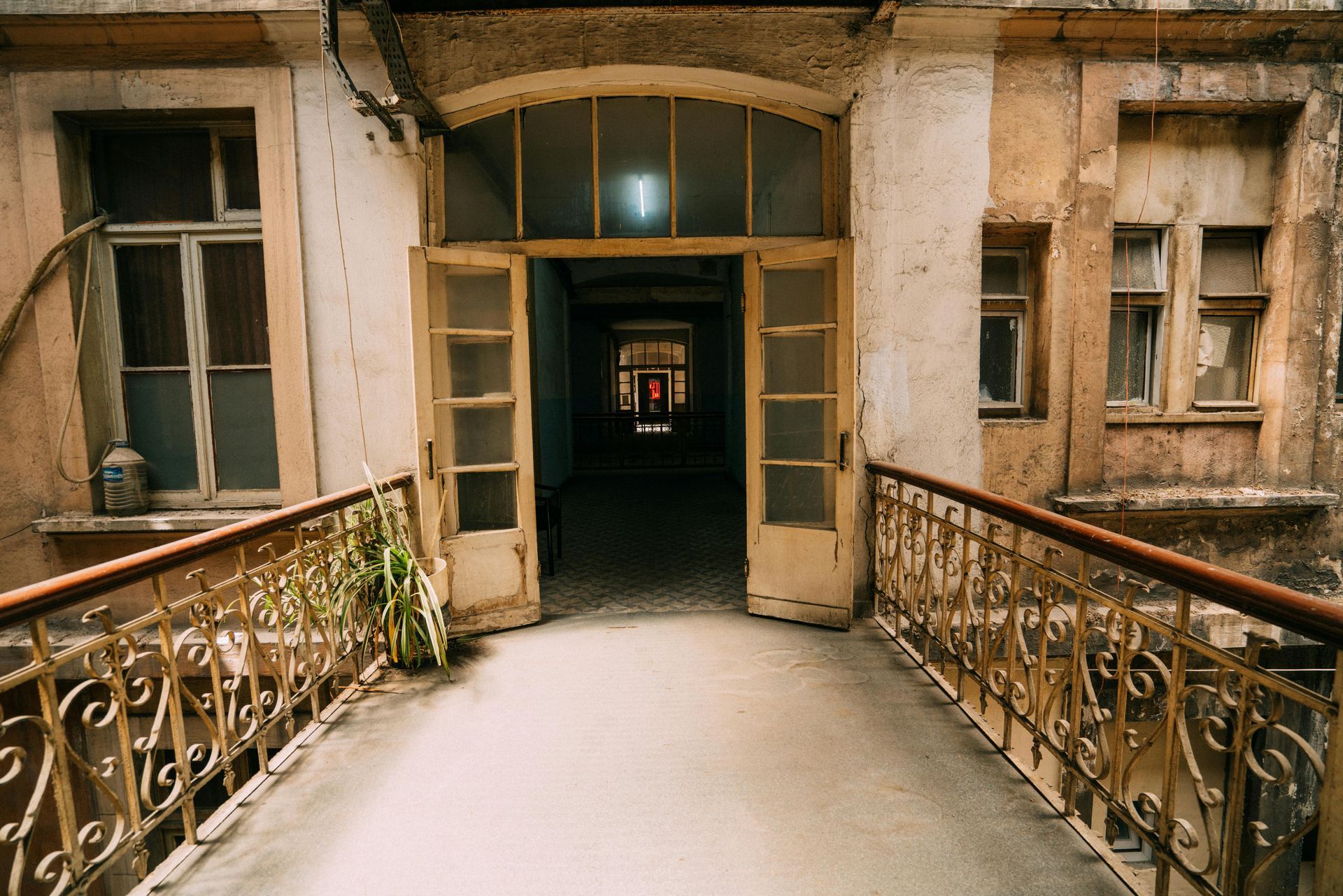 An old building with a bridge leading to a doorway.