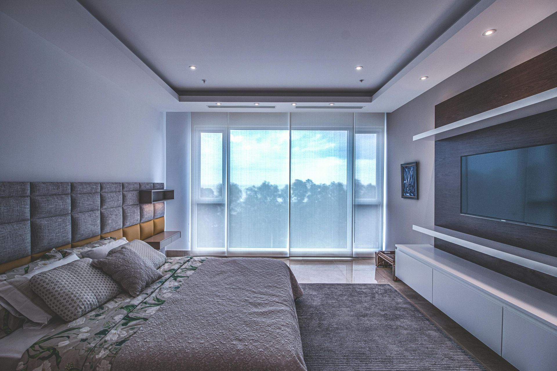 A bedroom with a large bed and a flat screen tv