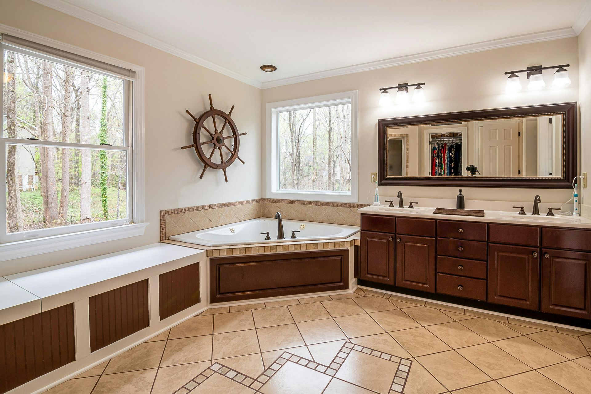 A bathroom with a jacuzzi tub and two sinks.
