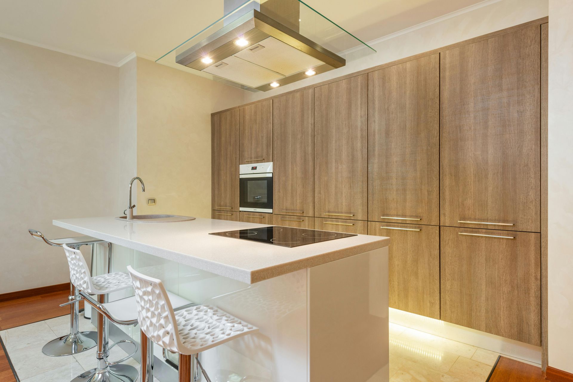 A kitchen with wooden cabinets and a stove top oven.
