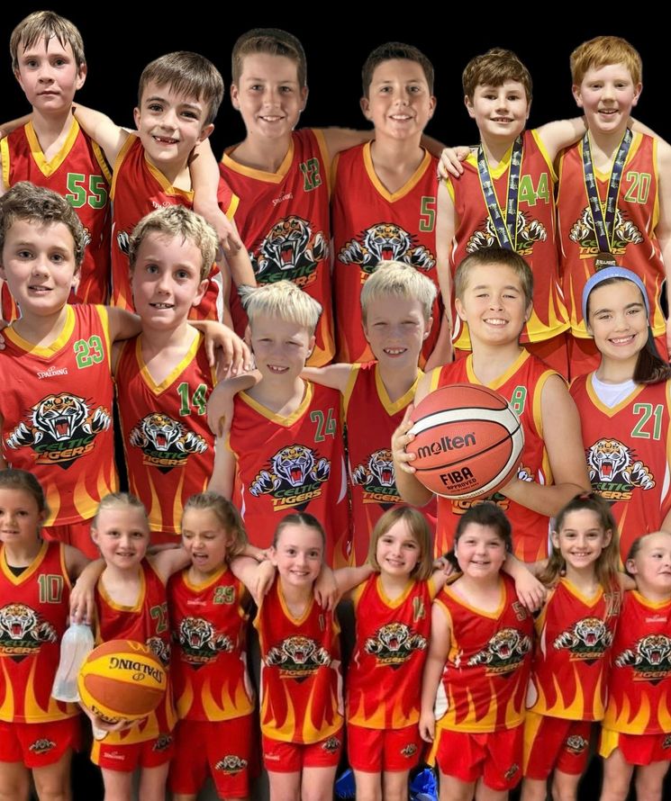 Youth basketball team in red and yellow uniforms posing together, holding a basketball.