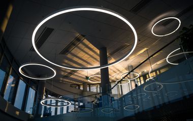 Modern interior with glowing circular ceiling lights and a central column